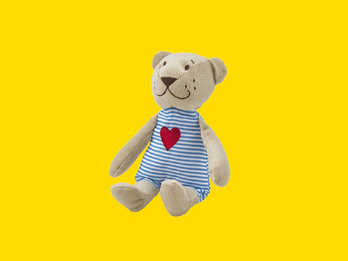 FABLER BJÖRN teddy bear in a blue striped suit with a red heart on a yellow background.