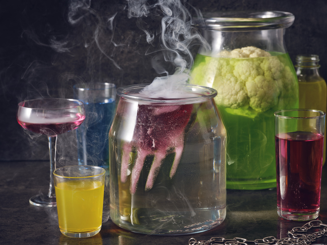 Jars with smoke, hand-shaped ice, and cauliflower for Halloween.