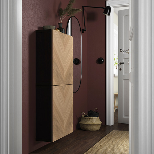 Pasillo moderno con paredes granates, armario alto de madera clara y negro, cesta y lámpara de pared. Puerta abierta a una habitación luminosa.
