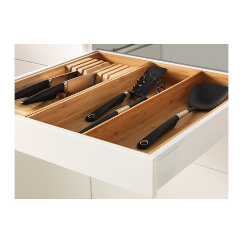 Kitchen drawer organizer with knives, utensils, and bamboo inserts for tidy storage.