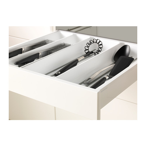 White kitchen drawer organizer with slots for knives and other utensils, part of the METOD system.