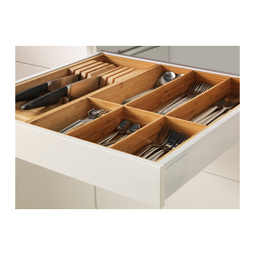 Open kitchen drawer with bamboo organizer for utensils and knives.
