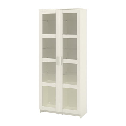 A white BRIMNES glass-door cabinet. Its rectangular with a minimalist design, showcasing tempered glass doors and shelves.