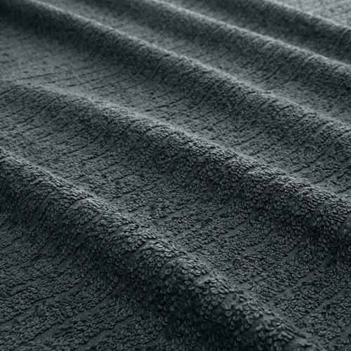 Toalla de color gris oscuro con una textura de rizo fina y suave, que muestra una artesanía de alta calidad.