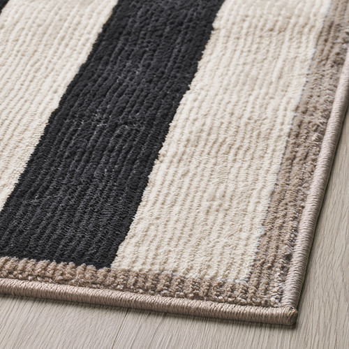 Alfombra de rayas con textura gruesa y suave; colores negro, blanco, beige; Materiales de alta calidad.