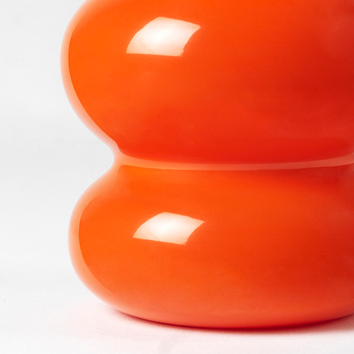 Jarrón de vidrio naranja brillante, superficie reflectante suavemente curvada, parte de la colección nytillverkad de ikea.