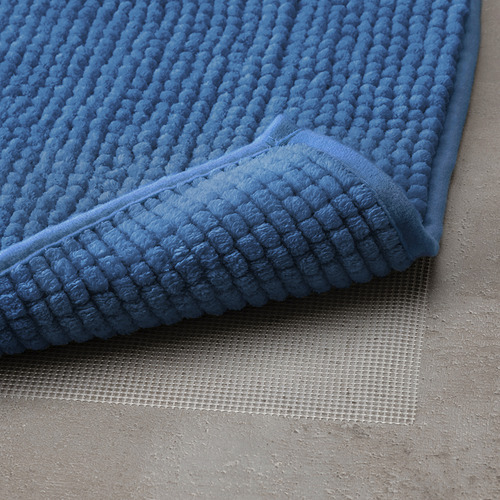 Alfombrilla de baño azul con superficie texturizada y antideslizante para mayor seguridad y comodidad.