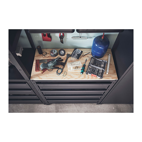 Un banco de trabajo BROR con cajones, con estructura gris y tapa de madera. Contiene varias herramientas y artículos, manteniéndolos organizados.