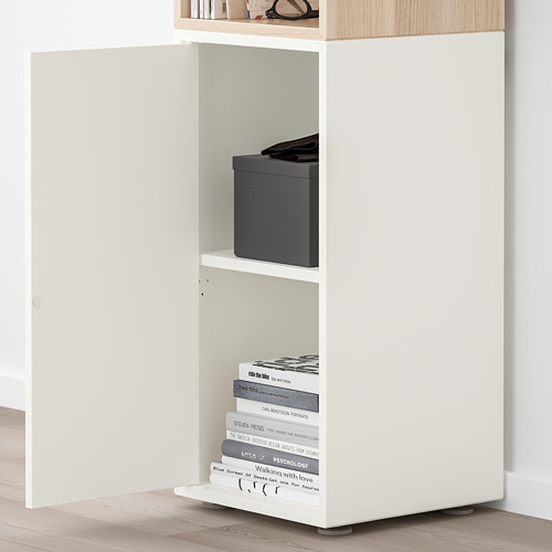 Estante EKET blanco, ajustable, fijado a la pared con libros y caja.