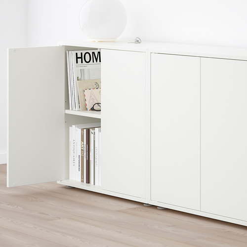 Open EKET storage cabinet with books, adjustable shelf, mirror above.