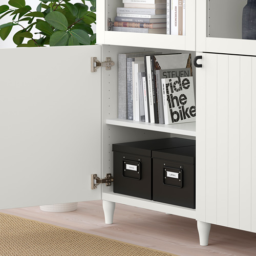 White cabinet with glass doors books; lower section hides black storage boxes labeled magazines.