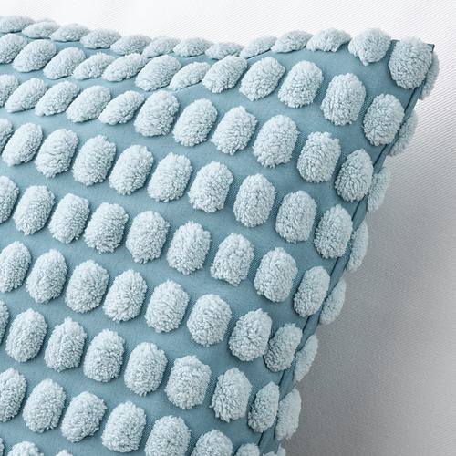 Decorative light blue pillow with soft, white, pom-pom-like accents, neatly arranged in rows, against a white background.