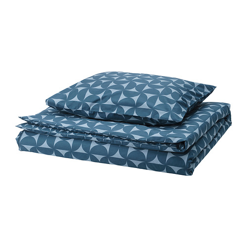 Blue geometric bedding set; square pillows, rounded shapes.