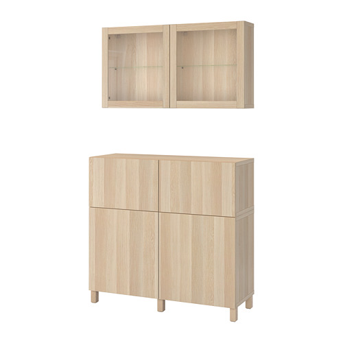 Wood BESTÅ cabinet set: tall unit with drawers, glass door; wall-mounted cabinets with glass doors.
