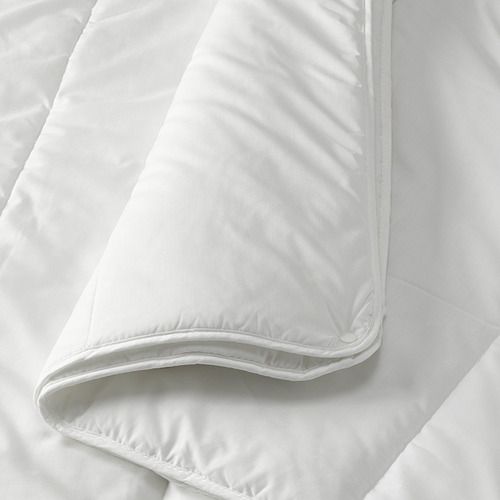 Folded white duvet on bed, soft and smooth fabric, neatly stitched edges.