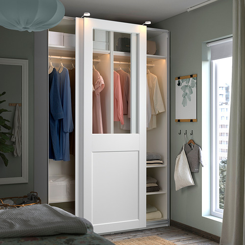 Organized bedroom with white PAX wardrobe, green walls, and cozy bed.