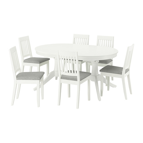White ROSENTORP dining set: oval table, 6 chairs. Chairs have gray cushions, wooden backs. Table extends for more seating.