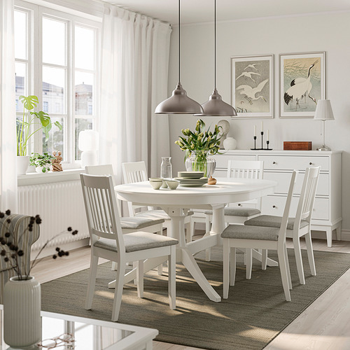 ROSENTORP dining set with extendable table and grey-cushioned chairs, under pendant lights, beside a large window and decorated sideboard.