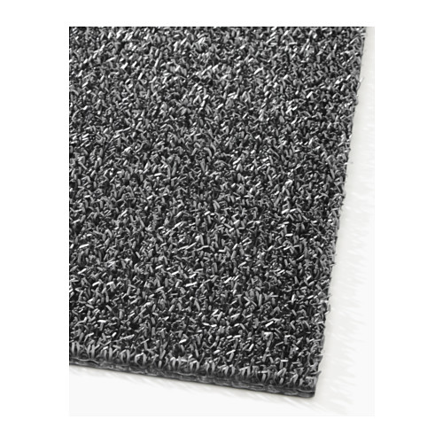 Primer plano de una alfombra de entrada texturizada de color gris oscuro con una superficie rugosa y duradera diseñada para uso en exteriores.