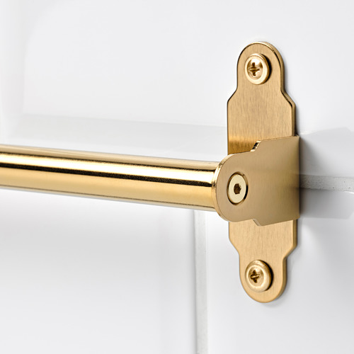 Toallero dorado fijado a una pared blanca con dos tornillos, diseñado por HULTARP, que ofrece un aspecto elegante y funcional.
