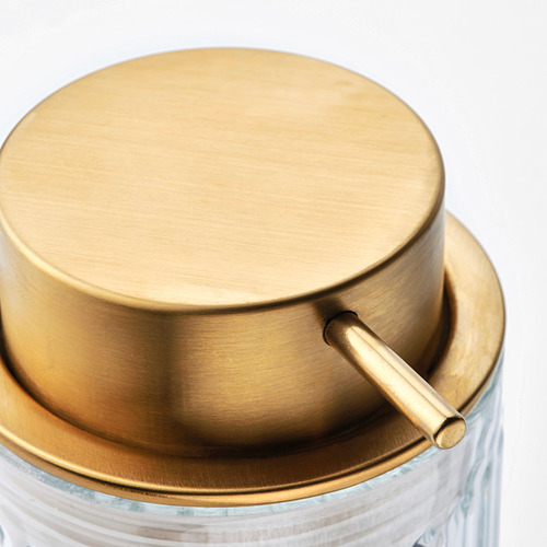 Tapa del dispensador de jabón teñido de oro con asa sobre base de vidrio transparente. Diseño moderno, materiales de alta calidad.