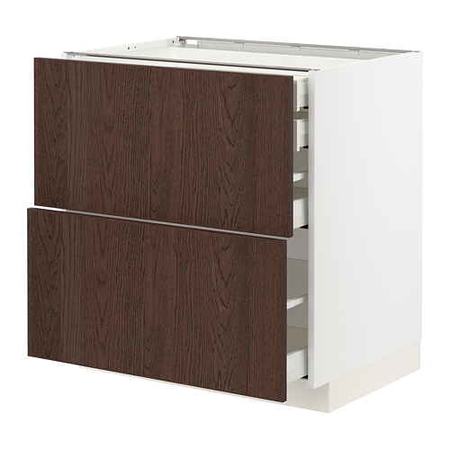 Mueble de cocina moderno con cajones de vetas de madera marrón oscuro y marco blanco, diseño elegante y minimalista.