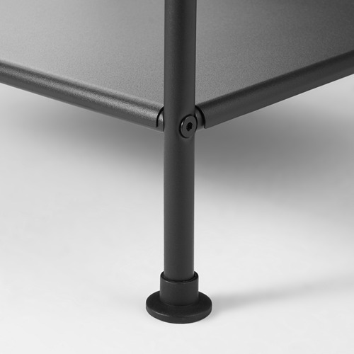 Pata de mesa de metal negro con pie redondo, fijada de forma segura a una superficie plana.