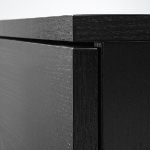 Esquina de muebles de madera negra, con un acabado liso y artesanal, resaltando la calidad.