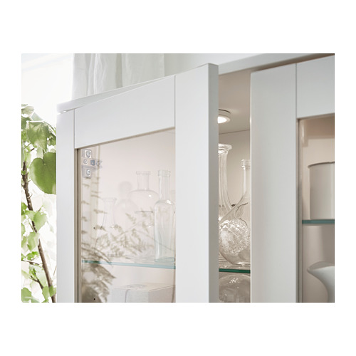 White glass-door cabinet with clear vases, modern design.