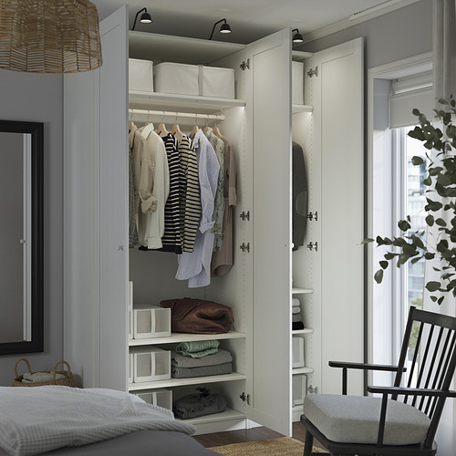 Open wardrobe displaying shirts on hangers, folded clothes, and storage boxes. Adjustable shelves and soft-close hinges.