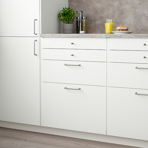 White VALLSTENA kitchen cabinet with six metal-handled drawers and countertop items.