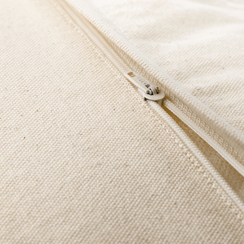 Primer plano de la funda de cojín beige con cremallera con sutil textura tejida.