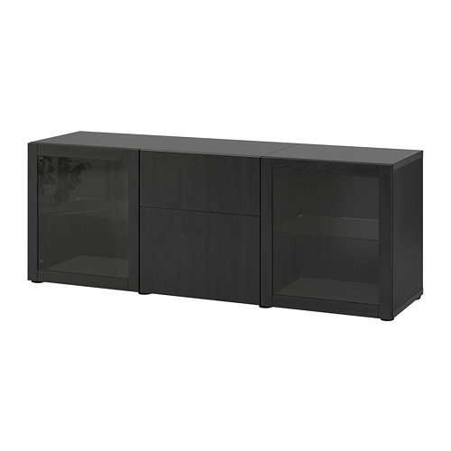 An ikea BESTÅ black sideboard with glass doors and drawers. It a rectangular shape for storage.