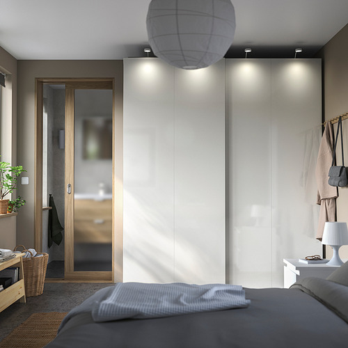 Modern bedroom with PAX wardrobes, sliding doors, gray bed, & soft lighting.