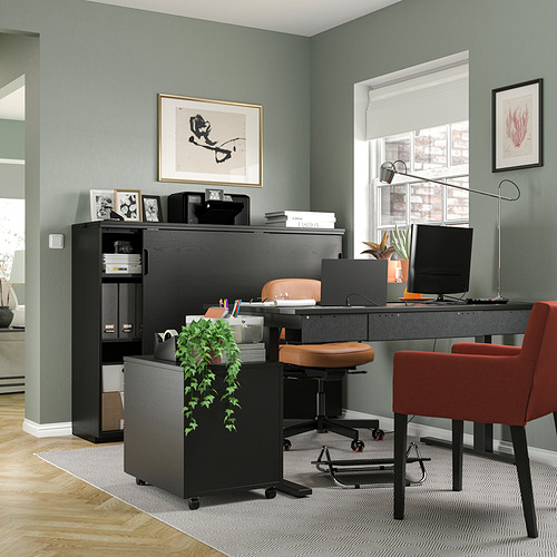 Moderna oficina en casa con paredes verdes, escritorio y almacenamiento GALANT negro, sillas rojas, computadora y arte decorativo.