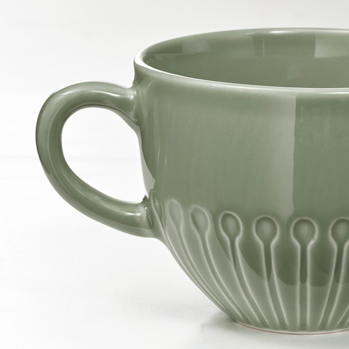 Taza floral verde con asa resistente.