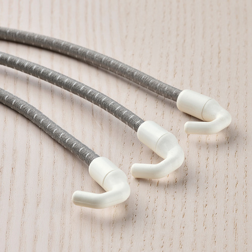 Tres cordones grises con ganchos blancos sobre madera.