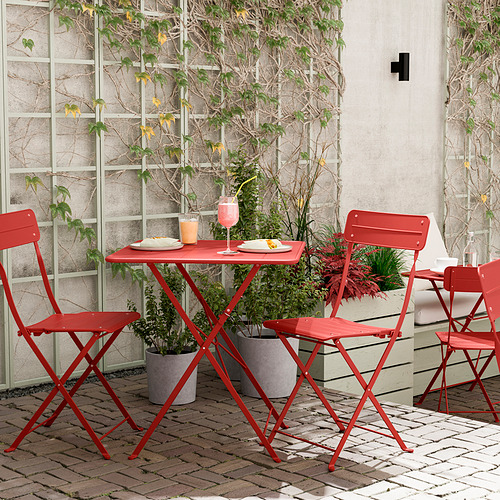 Conjunto de patio plegable rojo con mesa pequeña y cuatro sillas. Diseño moderno adecuado para espacios pequeños y balcones.