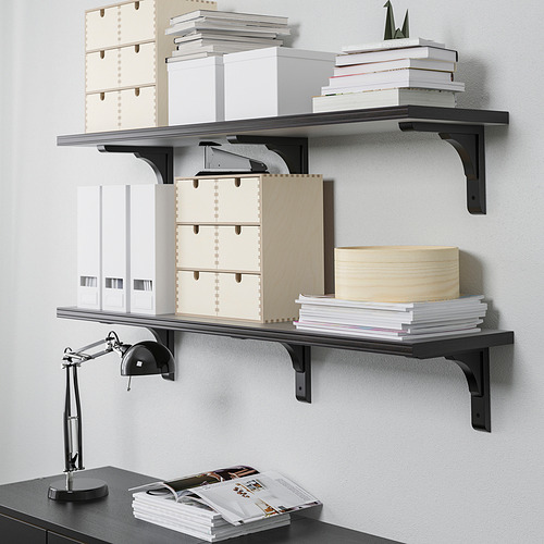 Shelves with books, paper, folders, and boxes. Desk lamp below.