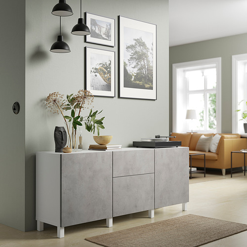 Gray BESTÅ sideboard near windows, with adjustable shelves and drawers. Decorated with a vase, bowl, framed pictures, and a rug. Hangs pendant lamps.
