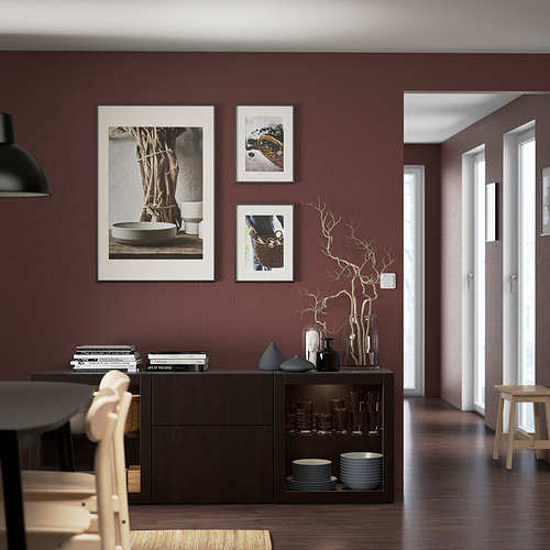 Modern dining room with dark red wall, black cabinet, wooden table, chairs, and decorative vases.