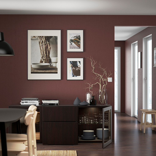 Modern dining area with maroon walls, dark sideboard, decorative items, framed prints, pendant light. Length: 50 characters