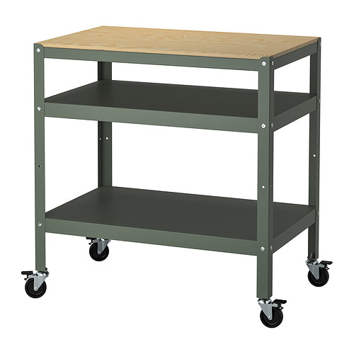 A BROR brand trolley in green. It a wooden top and two shelves, supported by a metal frame. It has four wheels for mobility.
