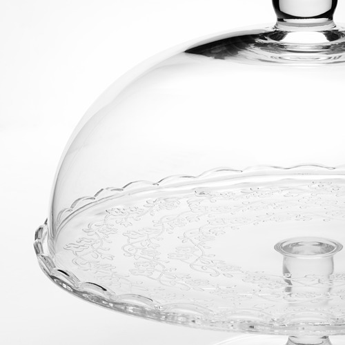 Soporte de vidrio para pasteles con diseños intrincados y tapa transparente. Ideal para servir postres con elegancia.