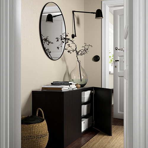 Modern hallway with BESTÅ cabinet featuring open doors, showing storage boxes inside, and mirror above.