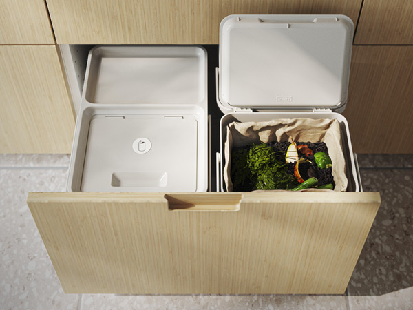 Open kitchen drawer featuring pull-out waste bins for recycling and organic compost.