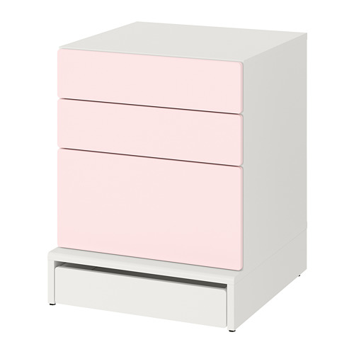 White chest of drawers with three light pink front drawers.
