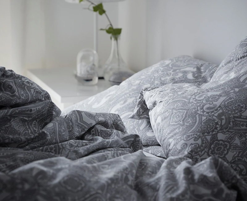 Soft gray and white paisley bedding, Duvet Cover, creates a cozy bedroom.