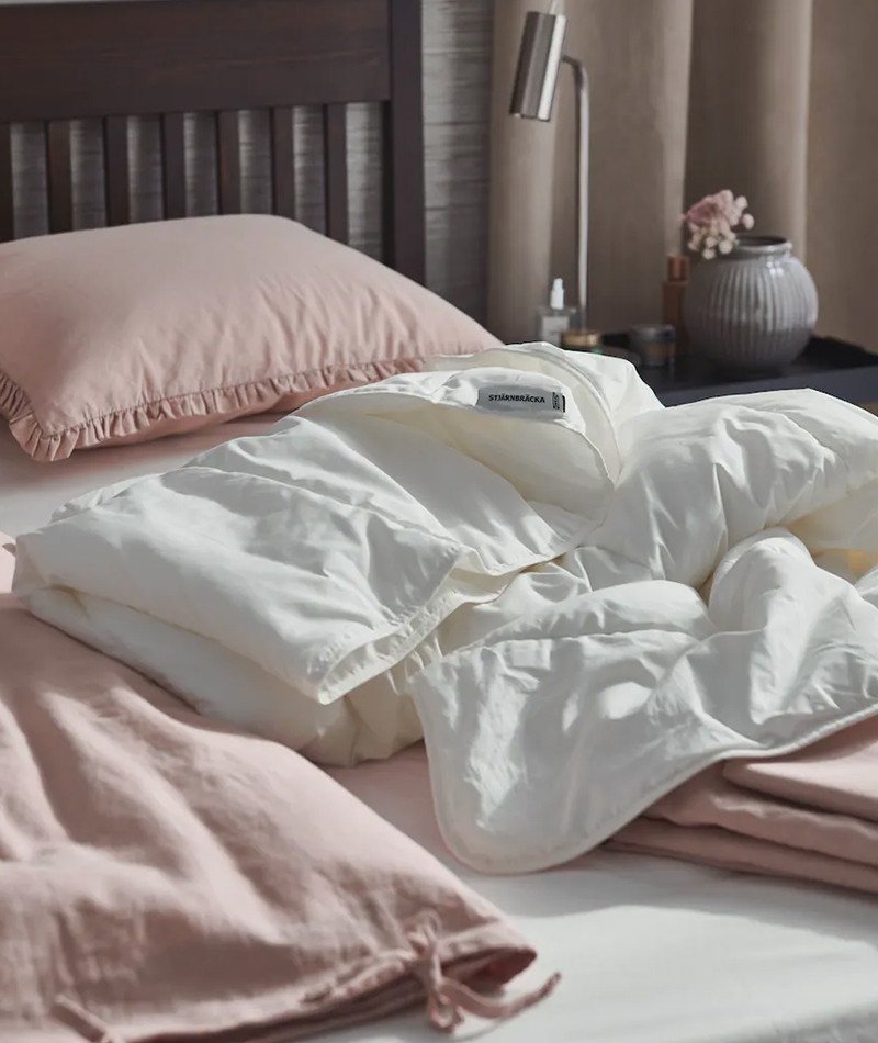 Soft pink IKEA BERGPALM bedding with a white duvet insert, creating a cozy and inviting bed.