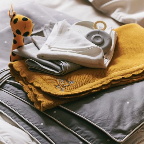 Baby textiles on a bed.
